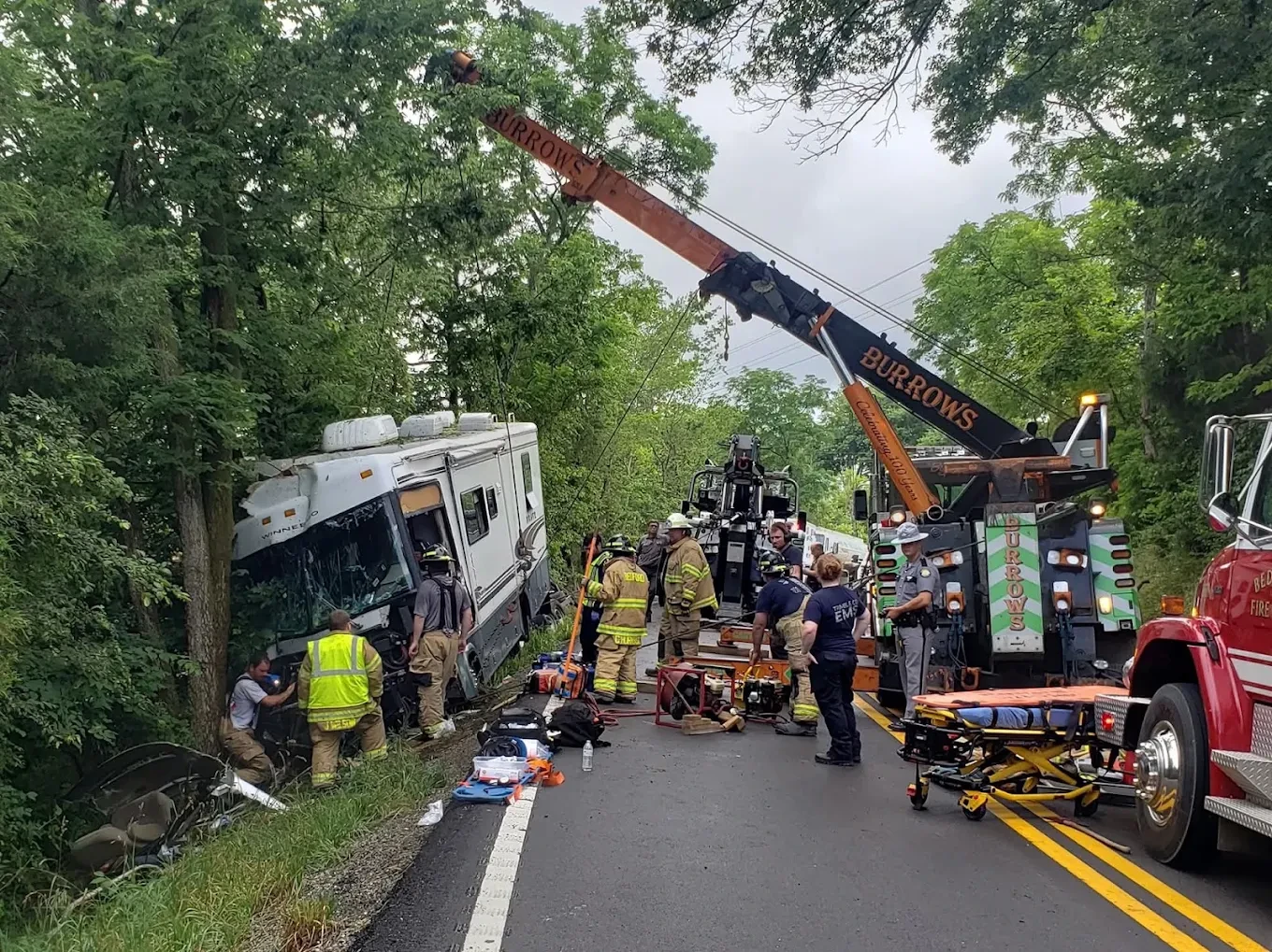 Burrows crew and emergency responders at an RV recovery scene