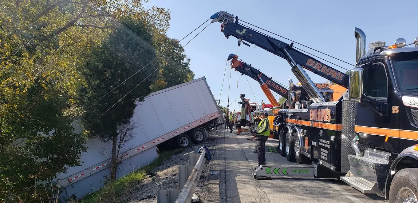 Burrows heavy-duty wreckers recovering a trailer from a roadside ditch